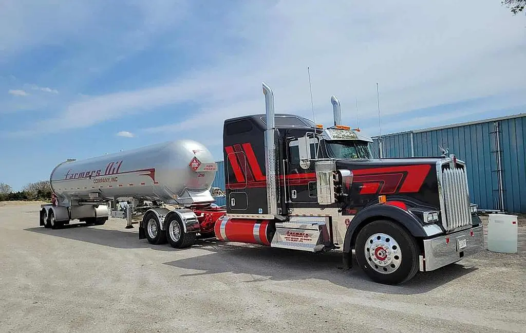 Black and red Farmers Oil Peterbilt with a white propane transport