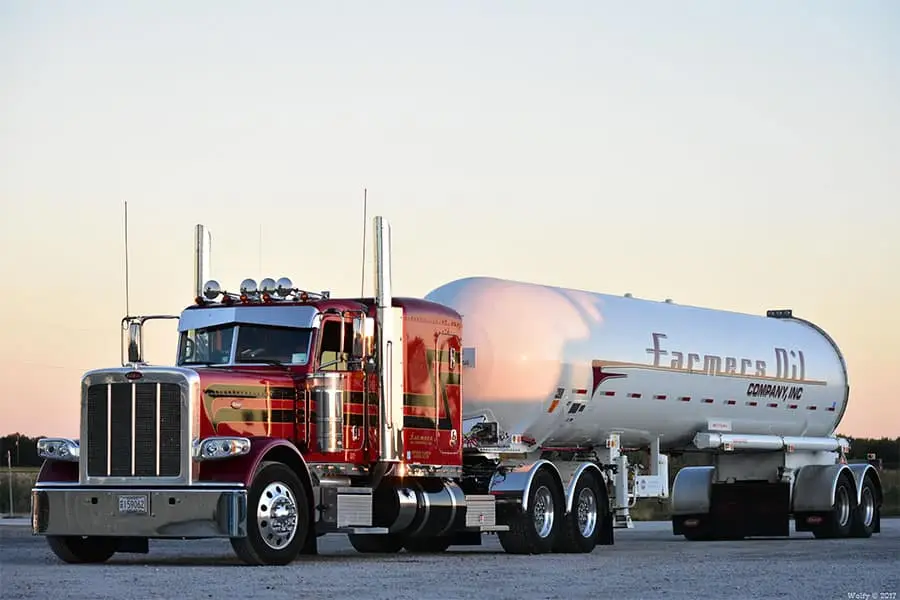 Maroon Farmers Oil Peterbilt and tank trailer at sunset