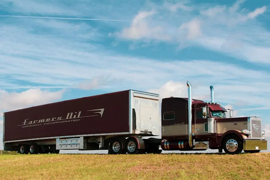Farmers Oil Peterbilt pulling a maroon Farmers Oil dry van