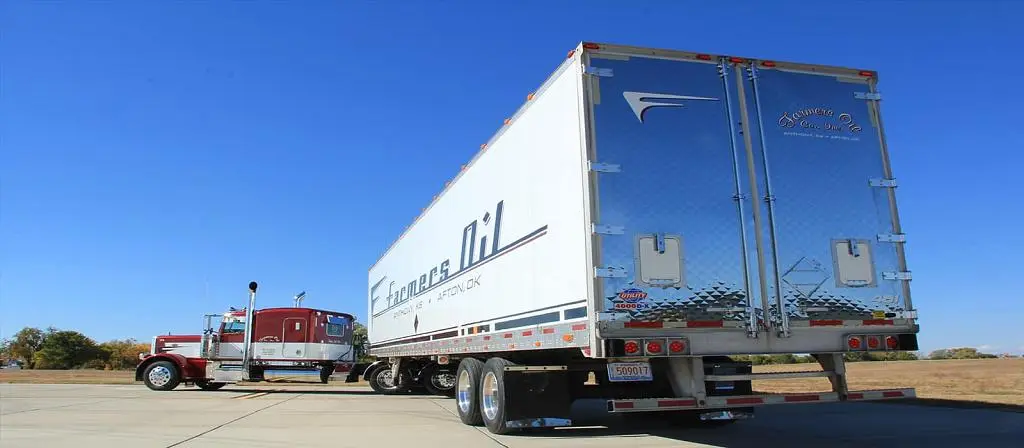 Farmers Oil Peterbilt with a white dry van trailer